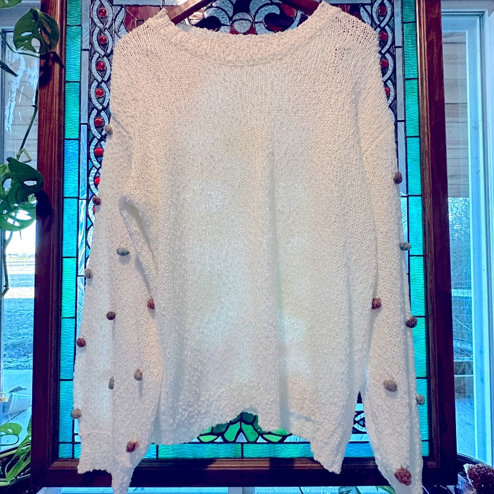 ee:some light knit sweater in white, deep neutral poms on sleeves. size:large